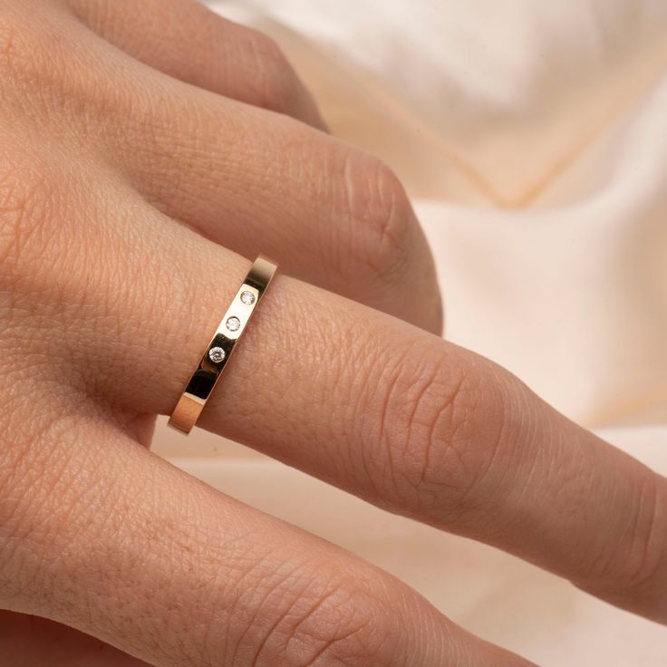 Fall in love with our 14k Flat Diamond Band .04CTW Classy and timeless. The perfect gift for that special someone, or simply as a reminder to love yourself. Featuring 3 Genuine ethically sourced 1.5mm diamonds Band thickness: 2.5mm Material: 14k Gold and Genuine Diamonds Minimalist Rings With Diamond Accents As Gift, Minimalist Rings With Diamond Accents For Gift, Classic Stackable Rings With Diamond Accents As Gift, Modern 14k Gold Engraved Ring For Wedding, Anniversary Bands In Polished Yellow Gold, Anniversary Yellow Gold Bands With Polished Finish, Timeless Yellow Gold Bands As Gift, Gift Stackable Rings With Diamond Accents, Anniversary Yellow Gold Polished Bands