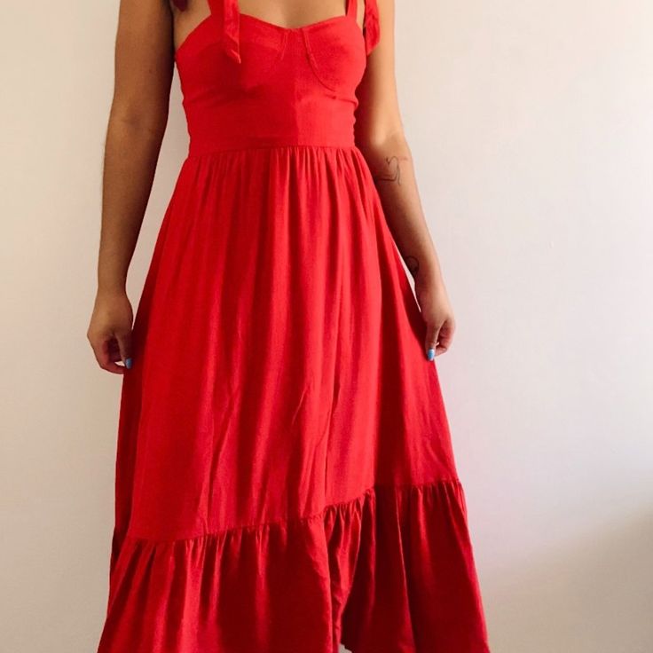 This Red Midi Dress With Self Tie Straps Is Fun, Flirty, But Yet Elegant. Whether You're Going On Vacation, A Date Night, Or Just Want To Feel Like A Princess This Dress Is For You! Red A-line Midi Dress For Brunch, Red Sleeveless Flirty Maxi Dress, Red Solid Color Summer Dress, Red Solid Color Midi Dress For Date Night, Red Solid Color Midi Dress For Summer, Summer Solid Color Red Midi Dress, Flirty Red Maxi Dress For Spring, Flirty Red Maxi Dress For Summer, Red Flirty Sundress For Vacation