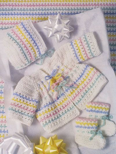 a baby's crocheted outfit and booties with a star on top