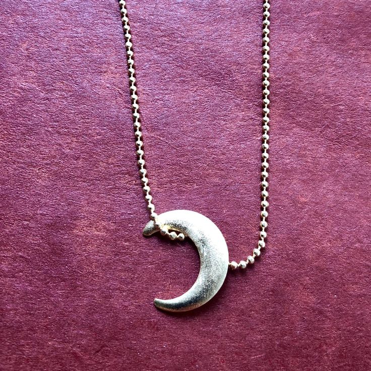 Handmade in Brazil. You will be "over the moon" about our Manduka Necklace. A delicate moon highlights the delicate ball chain to enhance any neckline. Chain is 16" long with 2" extender CO113 *Z* Adjustable Moon Shape Necklace With Moon Charm, Adjustable Crescent Moon Phase Charm Necklace, Adjustable Crescent Moon Charm Necklace, Everyday Moon Shaped Necklace With Delicate Chain, Adjustable Crescent Nickel Free Necklace, Nickel-free Adjustable Crescent Necklace, Over The Moon, Ball Chain, The Moon