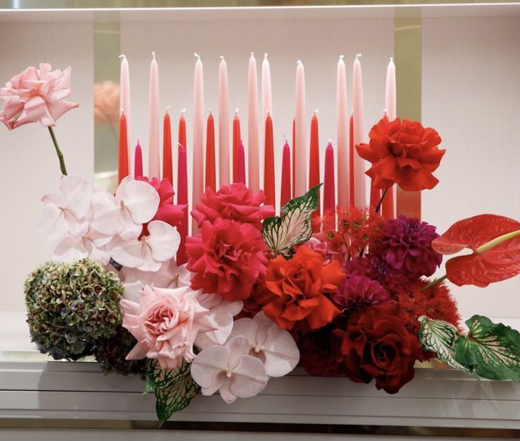 a bunch of flowers and candles on a table