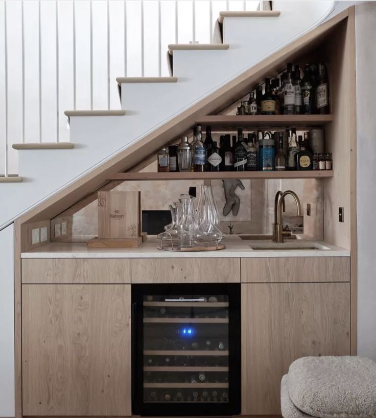 a wine cellar under the stairs in a home