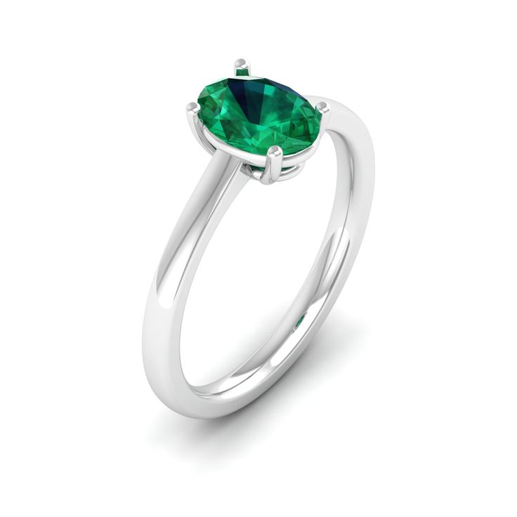 This elegant ring features a stunning oval emerald stone set in lustrous white gold. The vibrant green hue of the emerald is beautifully complemented by the brilliance of the white gold band, creating a timeless and sophisticated piece of jewelry. Metal: 14K Gold Setting Type: Prong Rhodium Finish: Yes, on White Gold Gemstone Details: Gemstone: Emerald Shape: Oval Average Dimensions: 8.00 x 6.00 MM Quantity: 01 Average Cut: Very Good Average Color: Medium to Dark Green Average Clarity: Eye Clean Oval Tsavorite White Gold Ring, Oval Tsavorite Ring In White Gold, Modern Oval Brilliant Cut Emerald Ring, Classic Oval Tsavorite Emerald Ring, Classic Green Emerald Oval Cabochon Ring, Oval Brilliant Cut Emerald Ring, Classic Green Oval Cabochon Emerald Ring, Green Oval Ring With Brilliant Cut, Green Oval Rings With Brilliant Cut