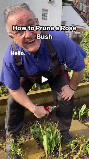 a man in blue shirt and black pants with gardening equipment on his hands, digging into plants