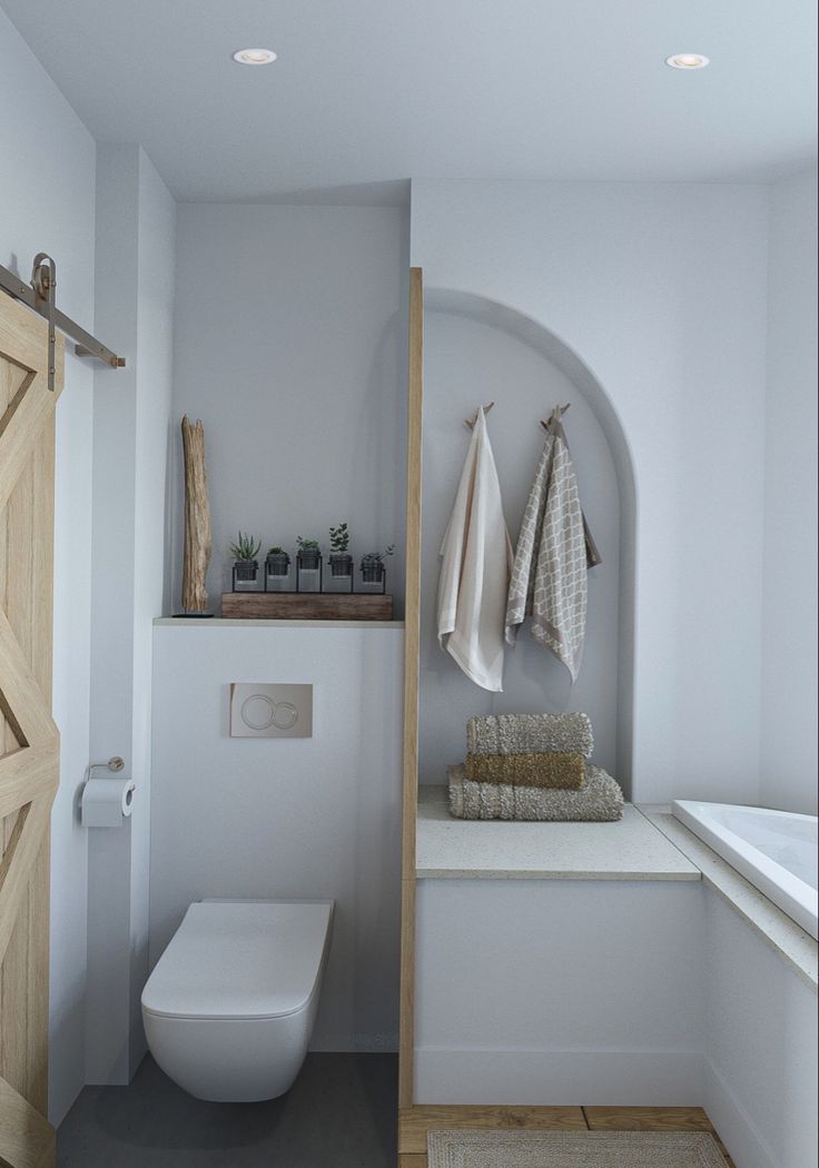 a bathroom with white walls and wooden doors