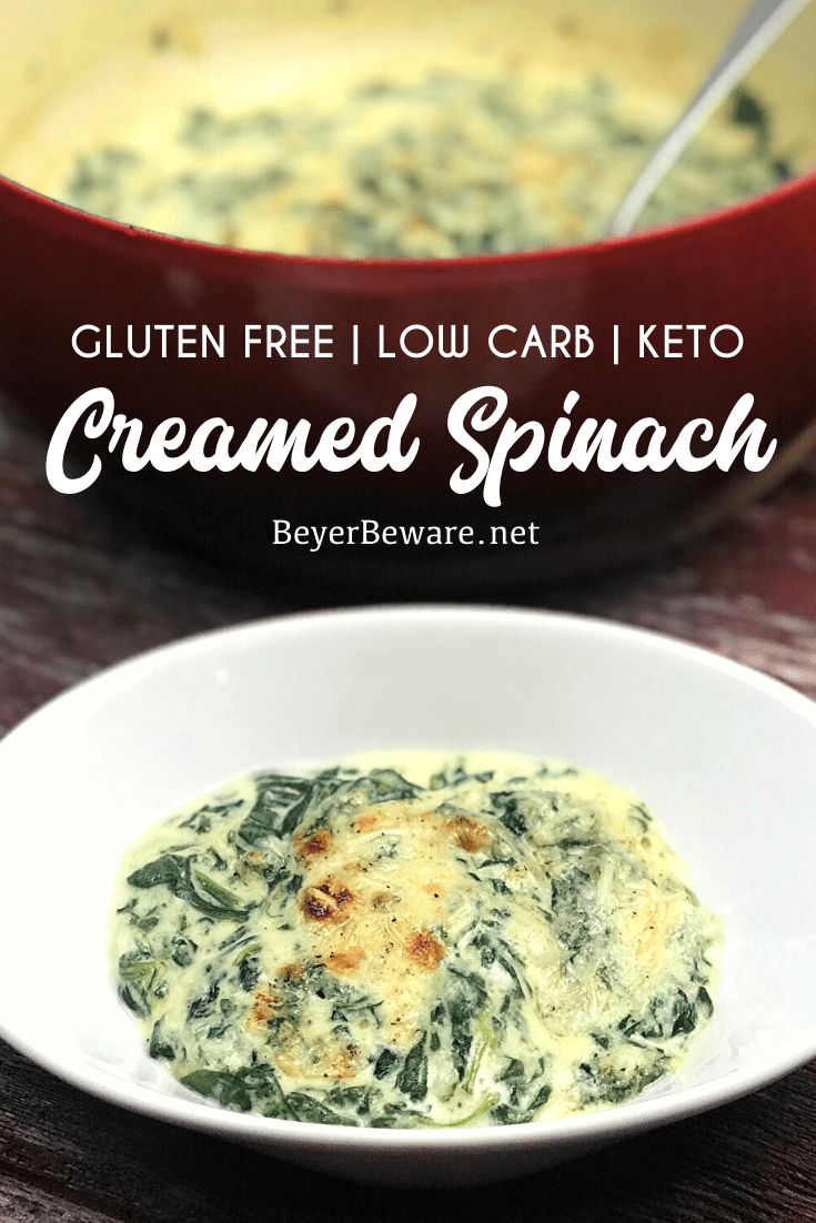 a white bowl filled with spinach and cheese next to a red casserole dish