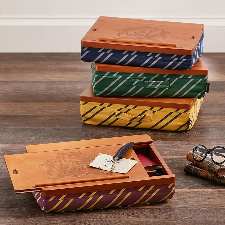 three wooden boxes with ties and glasses on the floor next to each other in front of them