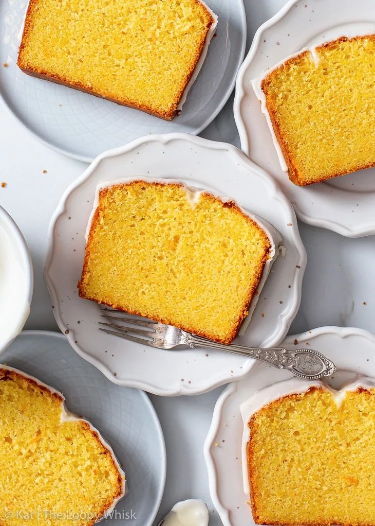 slices of cake on white plates with silverware