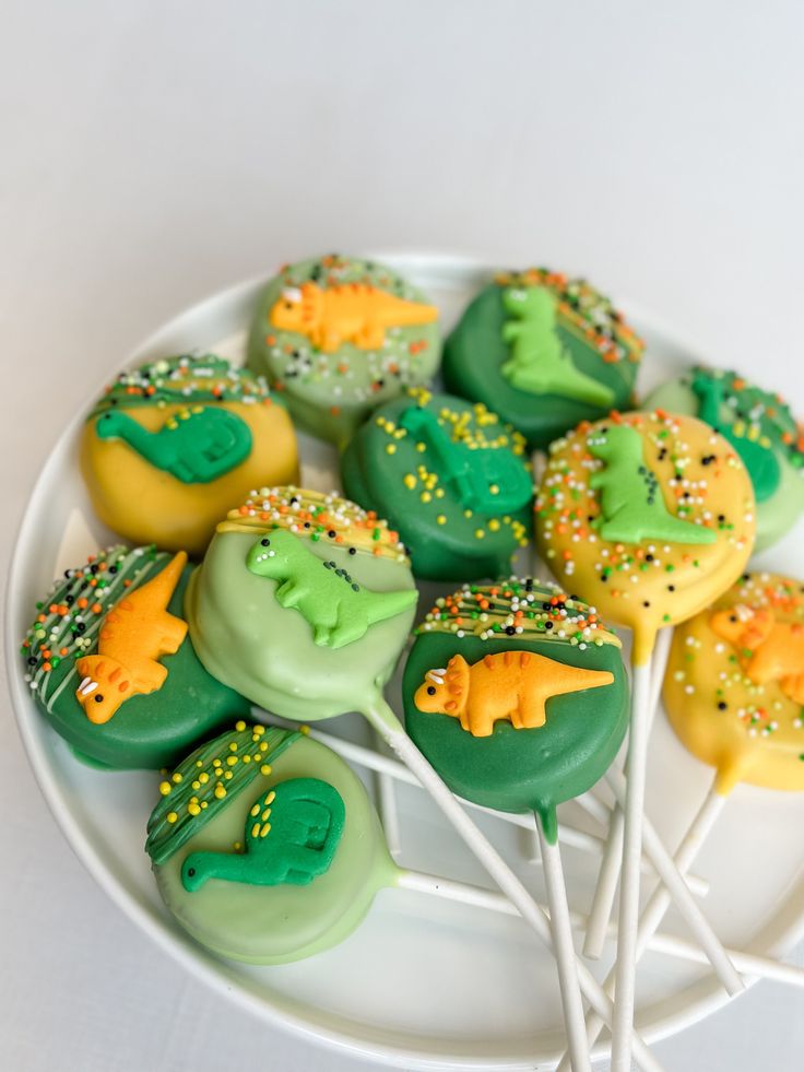 there are many green and yellow desserts on the white plate with toothbrushes