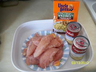 chicken and other food items are on a tray next to an unopened box