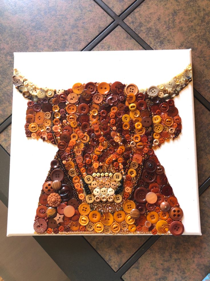 a bull made out of buttons on a white board