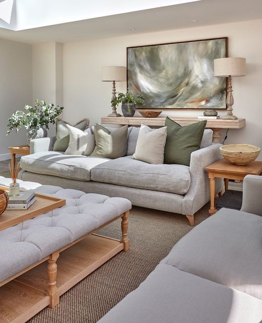 a living room filled with furniture and a large painting on the wall above the couch