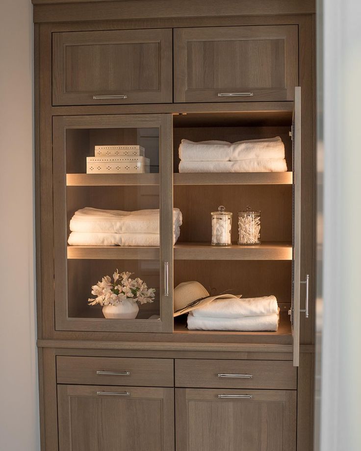 a cabinet with linens and towels in it