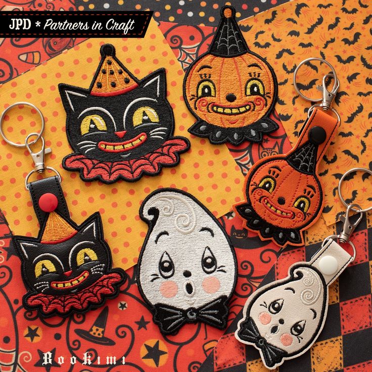 halloween themed keychains with black cats, pumpkins and jack - o'- lanterns