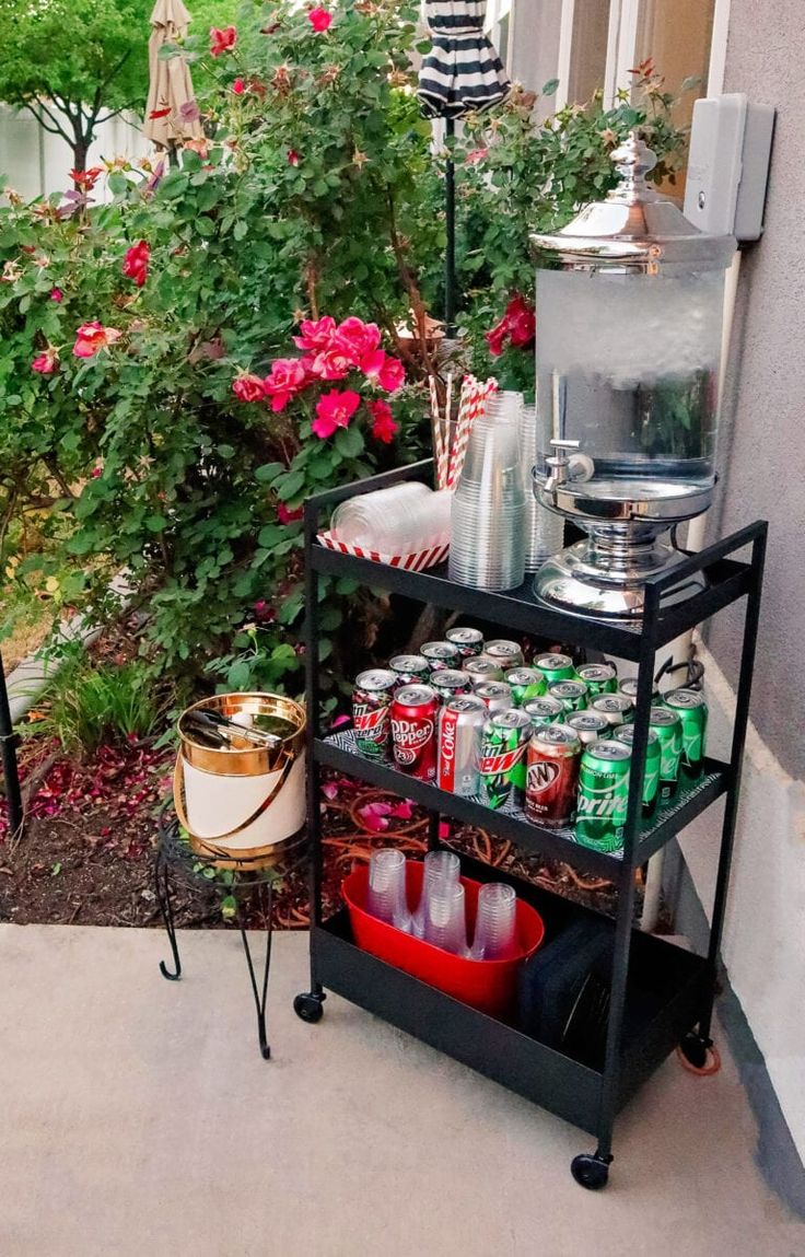 an outdoor bar cart with drinks on it