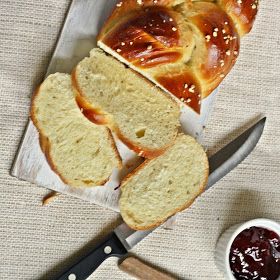 sliced loaf of bread sitting on top of a cutting board next to a knife