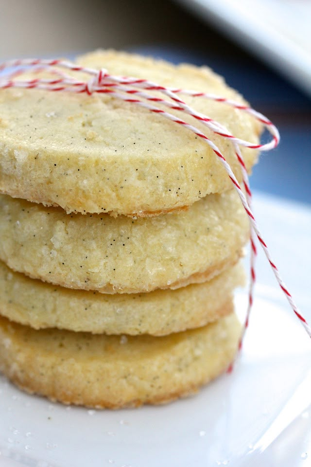 a stack of cookies sitting on top of a white plate next to a red and white string