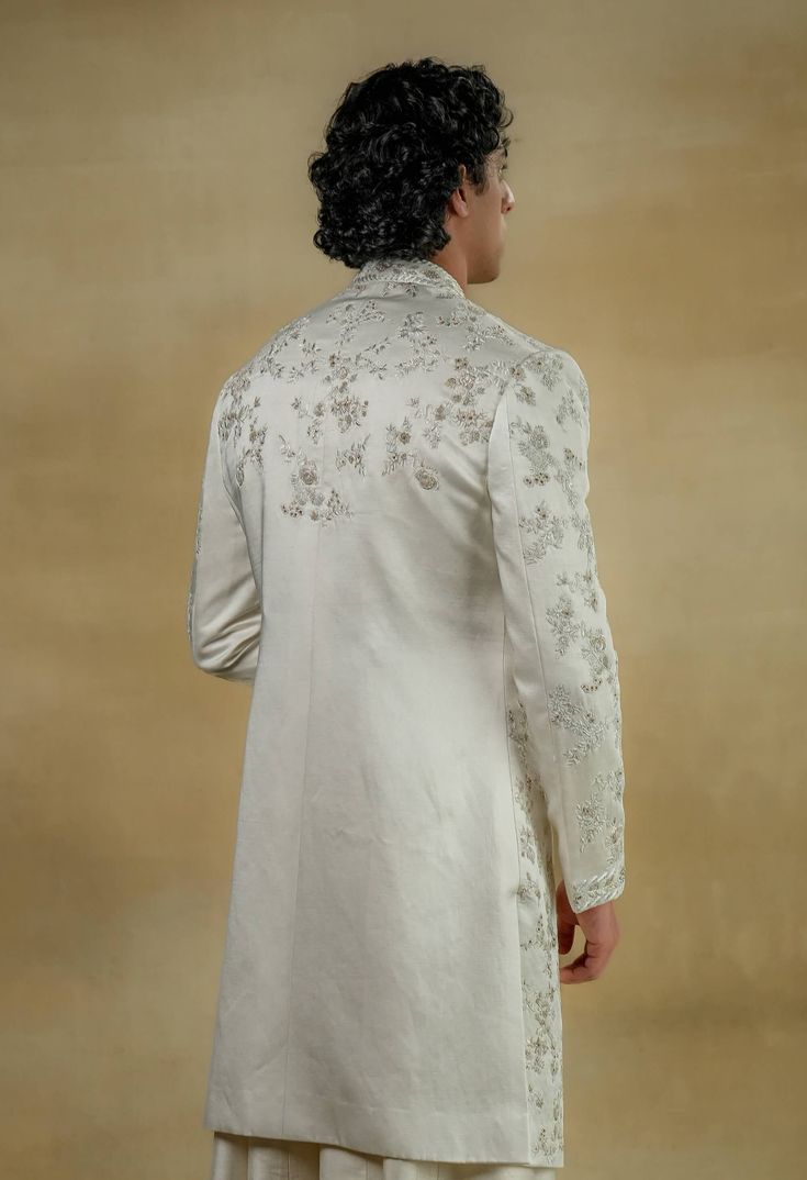 Editor's Note Featuring our work of art in our white all-over hand-embroidered sherwani set. The foundation is crafted using tone-on-tone thread along with silver zari work as a base texture. Fabric: Linen silk Color: White Components: Sherwani, kurta, churidar Occasion: Groom Fit: Regular Note: Product colour may slightly vary due to photographic lighting sources Care: Dry clean only About the Designer After establishing himself as the leading couturier in the industry of menswear, Jatin Malik Manpreet Toor, Jatin Malik, White Sherwani, Embroidered Sherwani, Blouse Yoke, Dhoti Pants, Texture Fabric, Haldi Ceremony, Royal Look