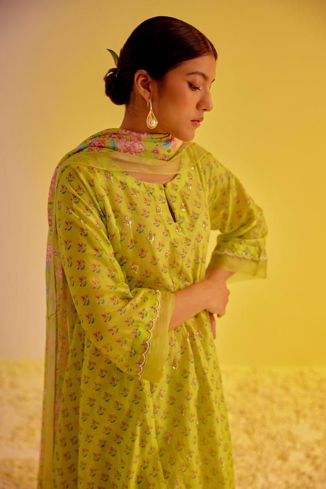 Light green A-line digitally printed kurta with hand embroidered detailings highlighting the booti, and scalloped sleeves with organza border. Paired with a straight pant and floral chintz pattern dupatta with scalloped organza border.
Components: 3
Pattern: Printed
Type Of Work: Floral
Neckline: Round
Sleeve Type: Three-quarter
Fabric: Chanderi
Color: Green
Other Details: 
Length:
Kurta: 46 inches
Sleeve: 16 inches
Pant: 37 inches
Approx. product weight: 1kg
Occasion: Mehendi and Haldi - Aza Fa Green Lawn Suit With Digital Print For Festivals, Green Digital Print Lawn Suit For Festivals, Festive Green Mulmul Palazzo Set, Green Chanderi Salwar Kameez For Summer, Fitted Lawn Suit With Digital Print For Festivals, Green Block Print Salwar Kameez In Mulmul, Traditional Chanderi Lawn Suit With Digital Print, Traditional Salwar Kameez With Digital Print For Spring, Designer Green Kurta For Spring