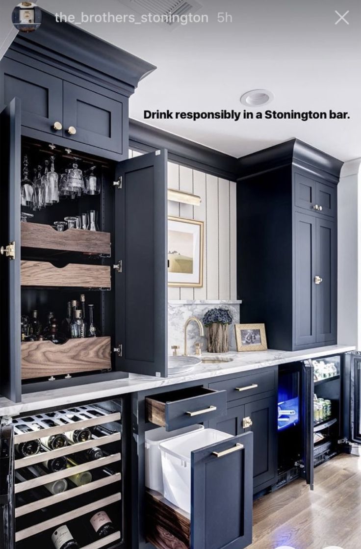 a kitchen with black cabinets and white counter tops