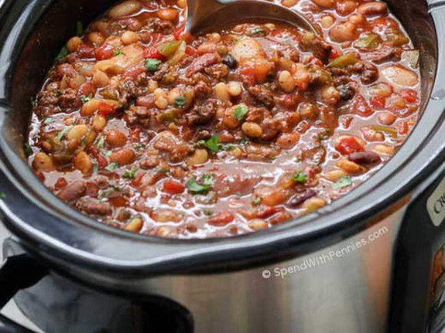 a slow cooker filled with chili and beans