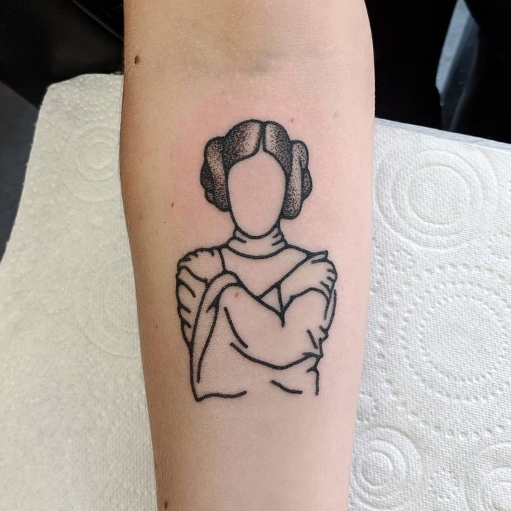 a woman's arm with a star wars character tattoo on the left side of her right arm