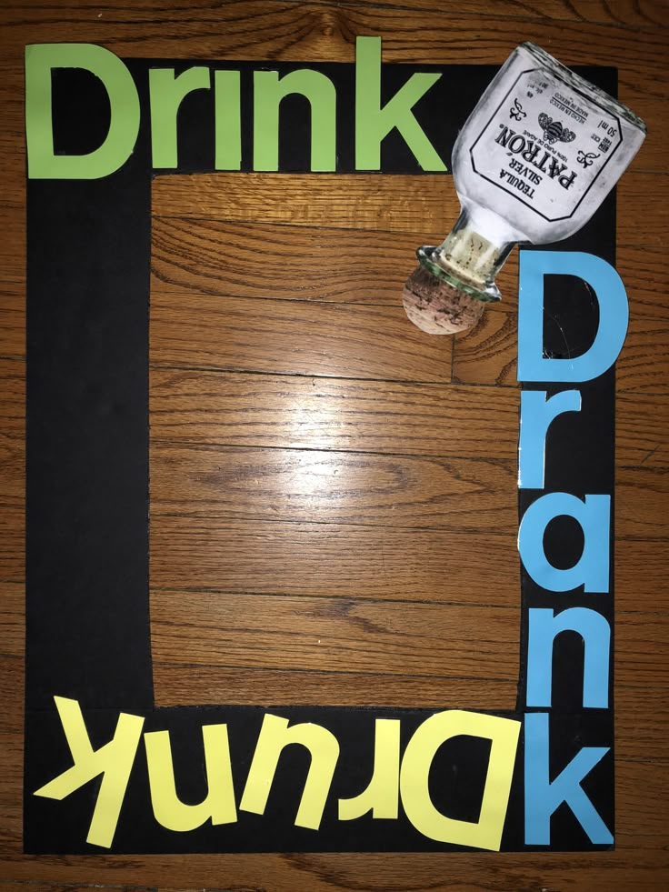 the word drink drunk is placed on top of a wooden table