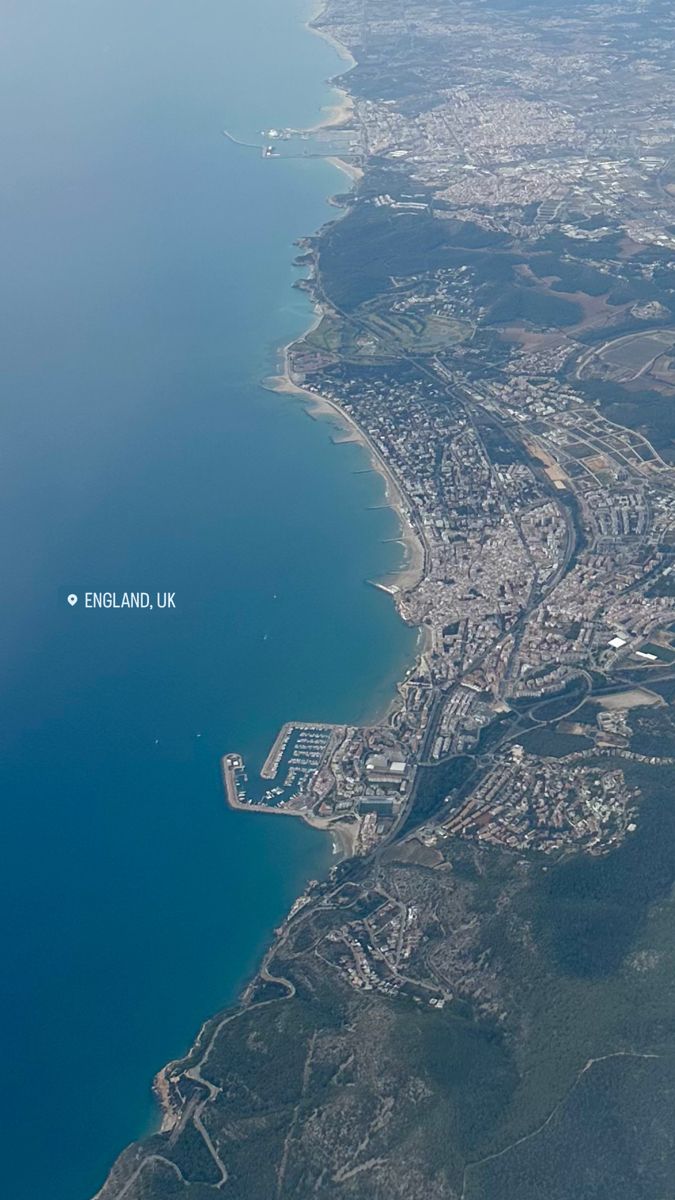 an aerial view of the ocean and land from above, looking down on england uk