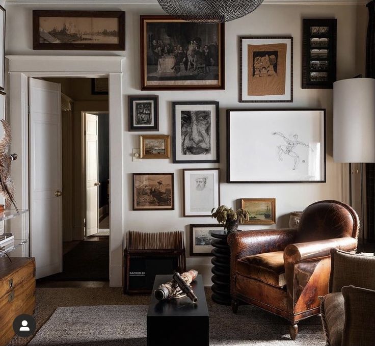 a living room filled with furniture and pictures on the wall