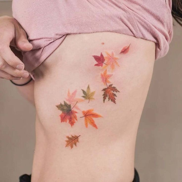 a woman's lower back with leaves on her stomach and the bottom half of her body