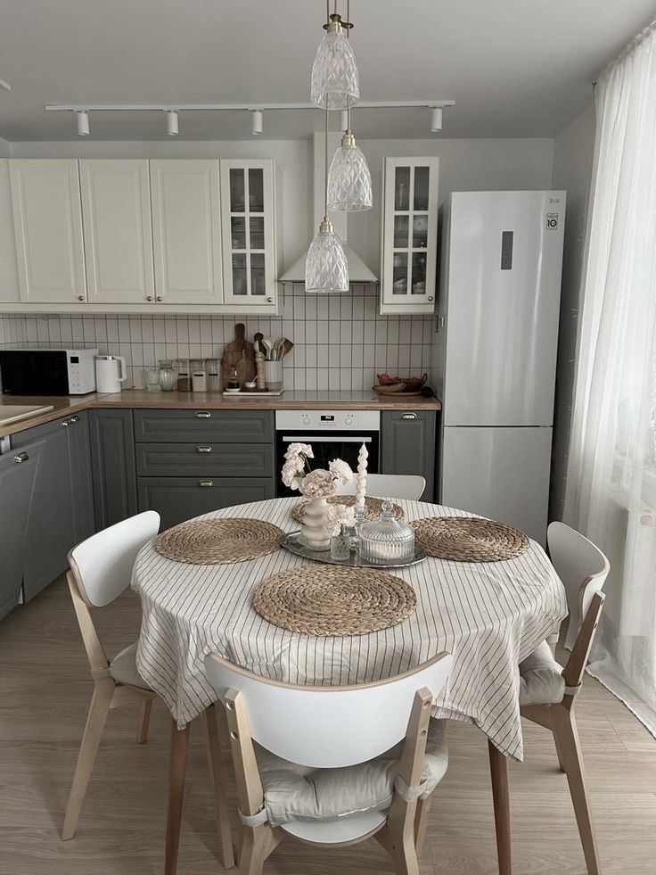 a kitchen with a table and chairs in it