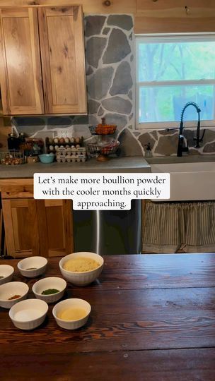 a wooden table topped with bowls of food next to a kitchen sink and counter top