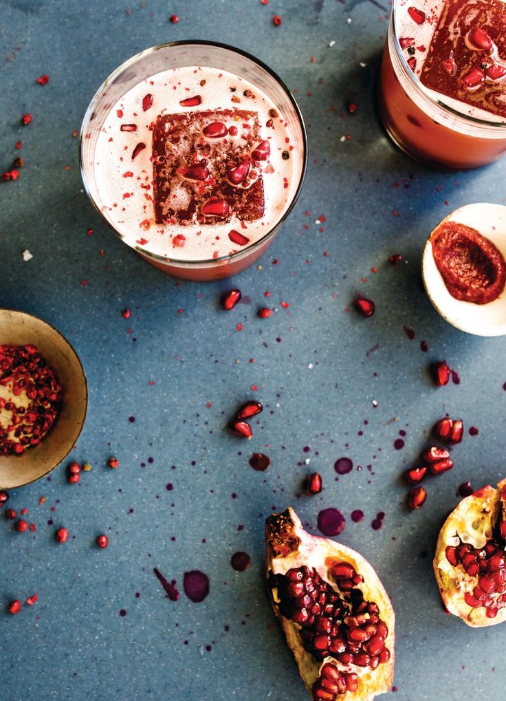 some desserts are sitting on a table with red sprinkles