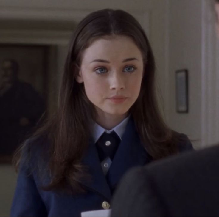 a woman in uniform standing next to a man with a name tag on her chest