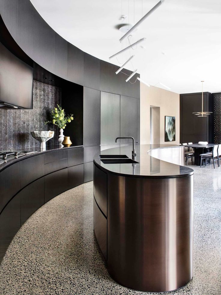 a modern kitchen with an island in the middle and lots of counter space on the other side