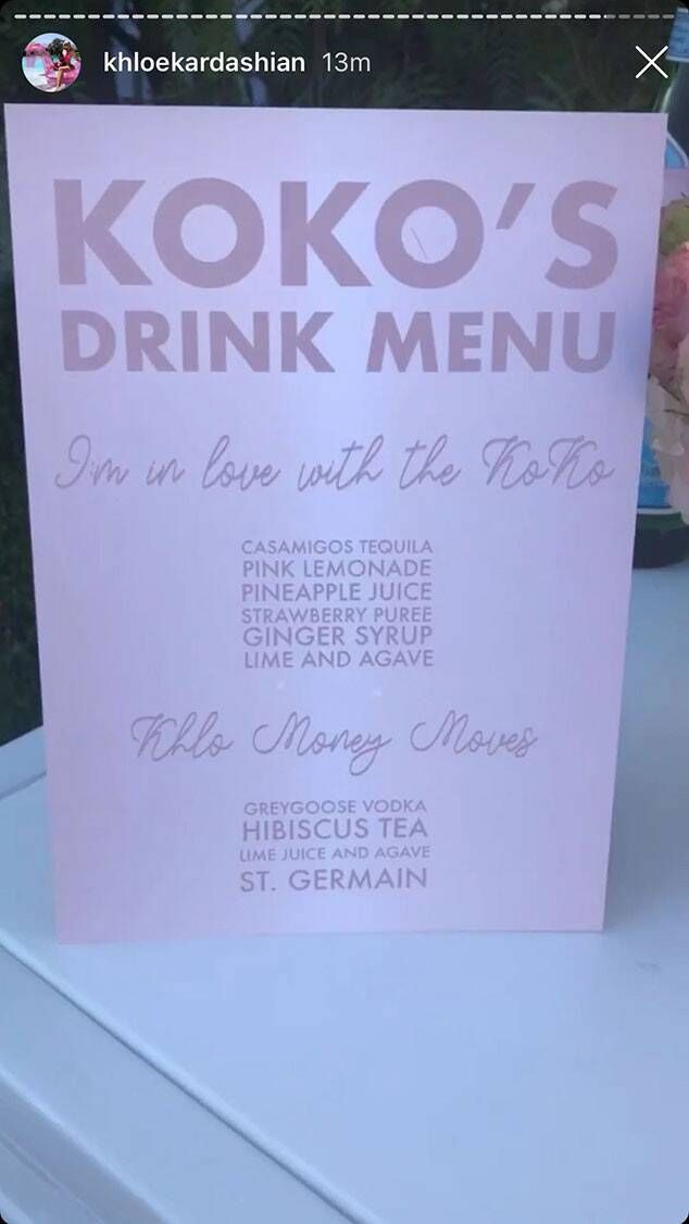 a pink sign sitting on top of a white table