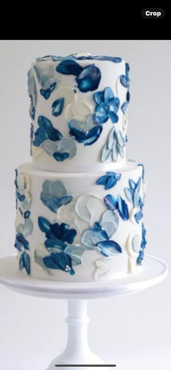 a three tiered cake with blue flowers on it