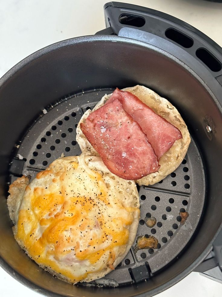 an open frying pan with eggs and ham in it