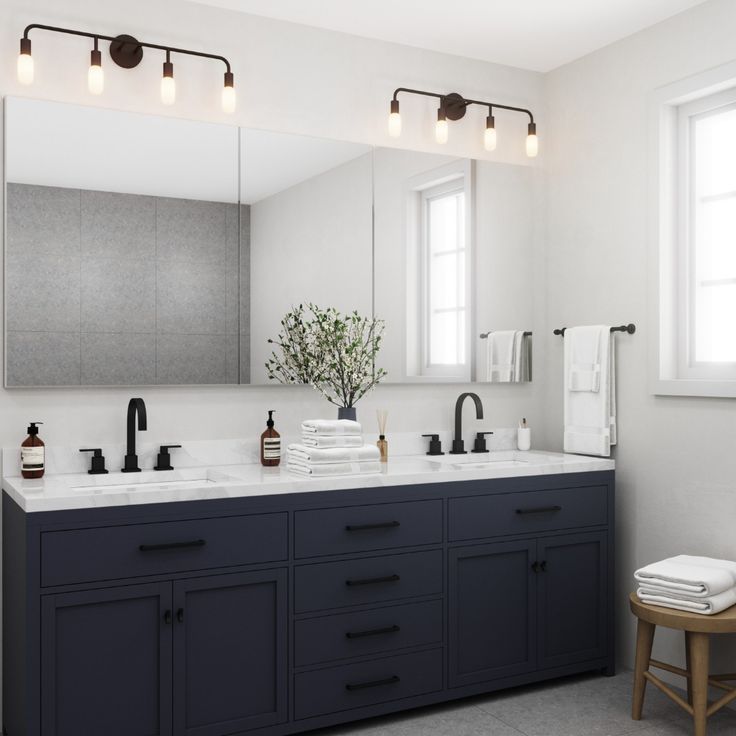 a bathroom with two sinks and mirrors in it