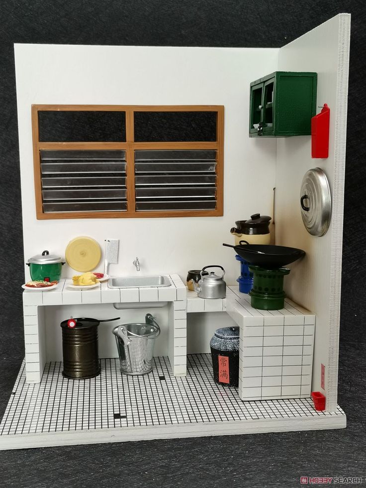 a dollhouse kitchen is shown with pots and pans