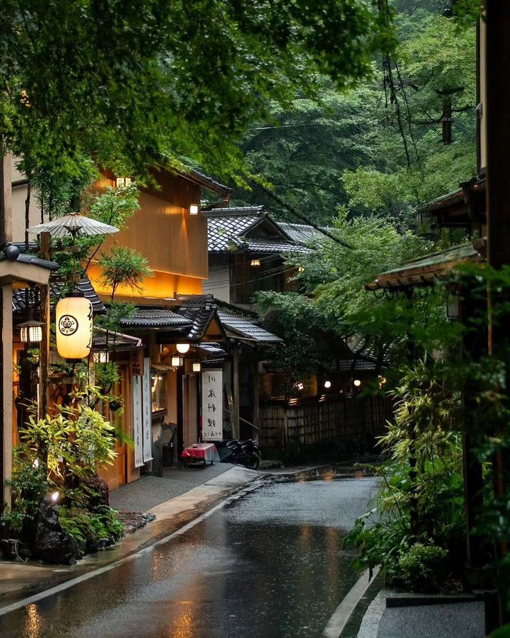 an alley way with buildings and trees in the rain