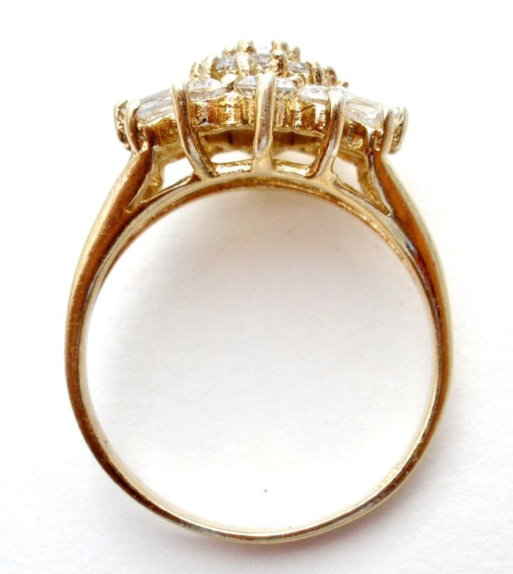 Fine Vermeil Jewellery - This is a gold over sterling silver cluster style cocktail ring with clear round and baguette cz's. The ring is a size 9, hallmarked 925, has approximately 3 carats of cubic zirconias, face measures 14mm by 16mm, weighs 4.2 grams. Gold Marquise Crystal Ring For Anniversary, Oval Gold Rings With Baguette Diamonds, Formal Baguette Diamond Cluster Ring, Formal Cluster Ring With Baguette Diamonds, Formal Cluster Ring With Baguette Diamonds, Round Cut, Dazzling Gold Cluster Ring With Center Stone, Gold Cluster Ring With Vs Clarity, Cluster Ring With Vs Clarity Cubic Zirconia, Gold Rings With Halo Setting In Baguette Cut