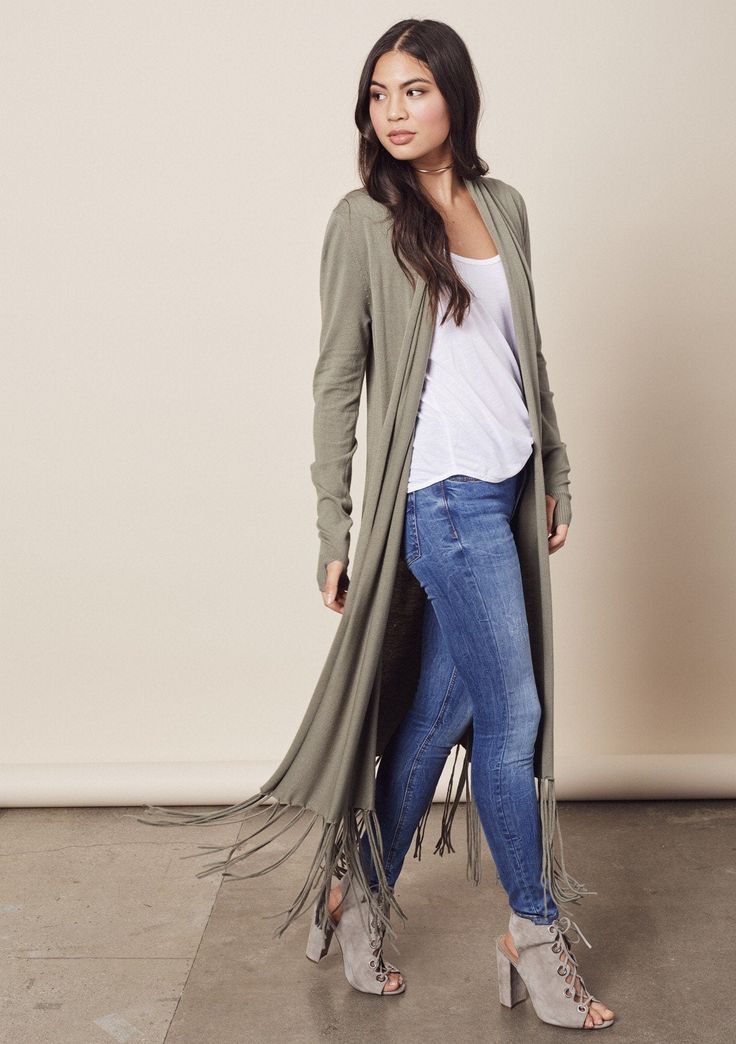 Effortlessly chic, long-sleeved open cardigan duster featuring thumbholes and a long fringed hemline. FINAL SALE Relaxed fit Long sleeve with thumb holes Long duster length Fringe hemline Open front 55% Nylon, 25% Viscose, 20% Modal Model is 5'9, wearing a size S. Style: I-50135NW Green Duster Outfit, Duster Outfit Fall, Duster Outfit, Knit Duster, Duster Vest, Long Duster, Vest Outfit, Sweater Duster, Lightweight Cardigan