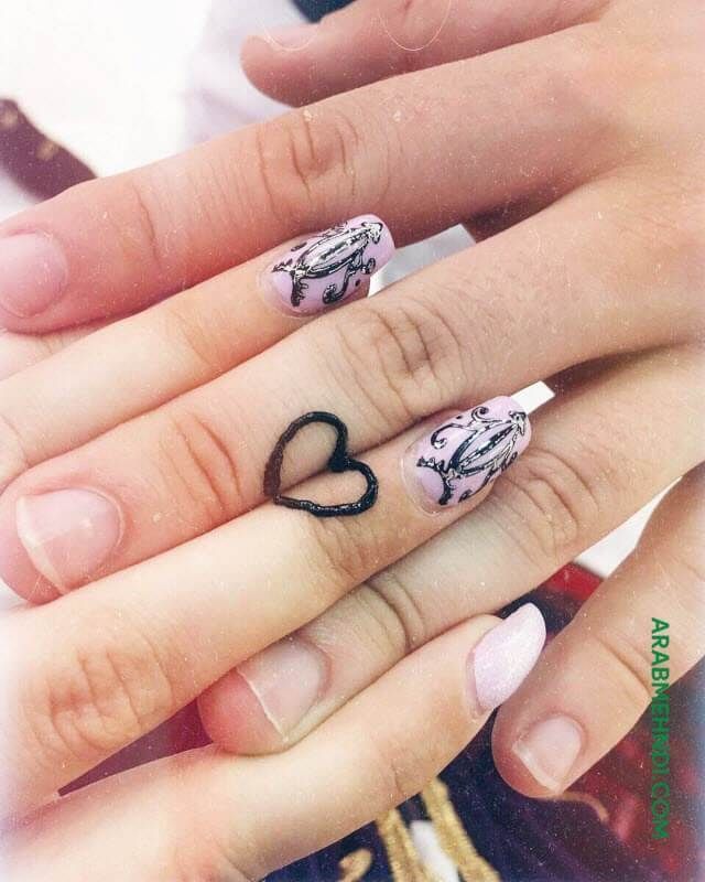 two hands with different designs on them and one has a heart shaped ring in the middle