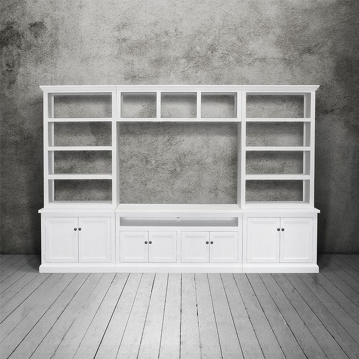 an empty white entertainment center with shelves and drawers