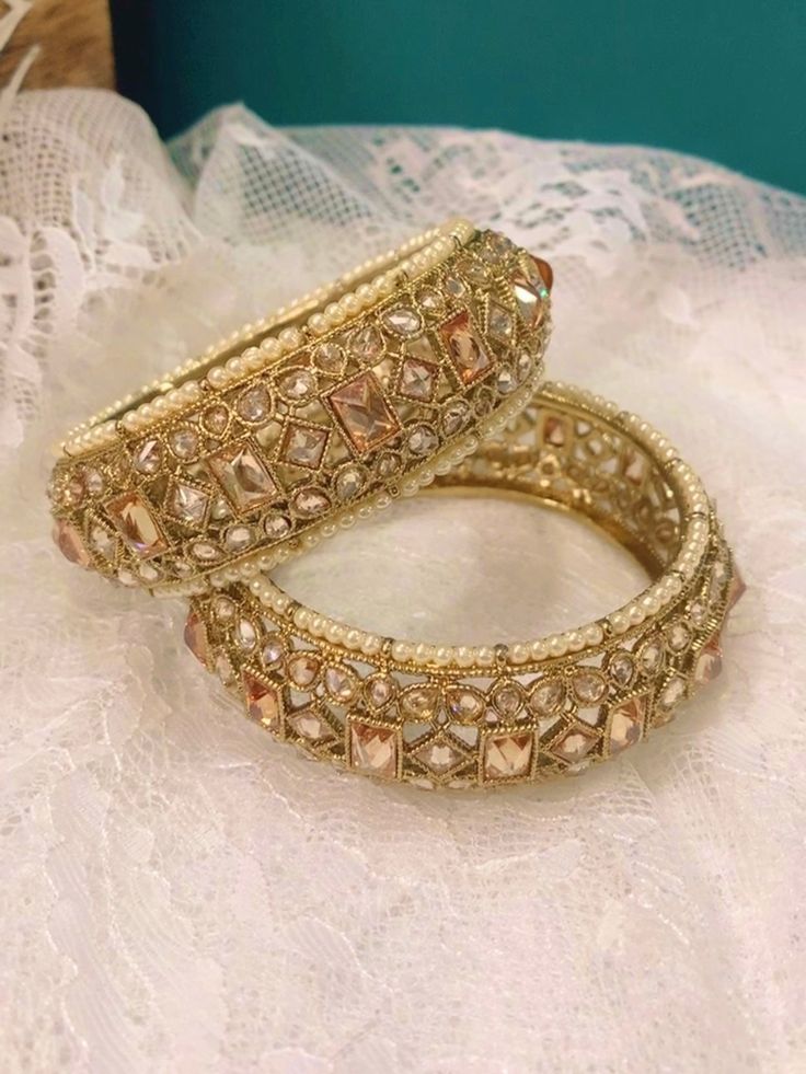 Polki pachili style bangle Shaila in antique gold. Antique based and champagne stone. Pearl lining . About one inch in width. Brass made. Top class polki. Heavy Kundan Bangle For Wedding, Traditional Wedding Bangle With Stone Work, Hand Set Kundan Bollywood Bangle, Bollywood Kundan Bangle With Hand Set, Heavy Bollywood Bangle For Weddings, Gold Tilla Bangle For Party, Zari Work Bangle For Diwali Party, Bollywood Kundan Bangle For Wedding, Traditional Festive Bangle With Stone Work