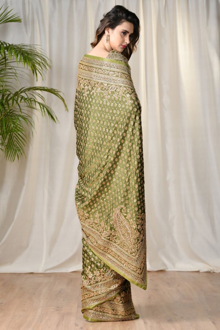 Editor's Note This set features a green embroidered paisley saree with unstitched blouse printed with garden of eden. Neck: Round Neck Sleeve Type: Short Sleeves Fabric: Satin Care: Dry Clean Only   Customize Your Outfit Can't find the size you're looking for? No stress. Just select size "Custom" while adding the item Semi-stitched Green Embroidered Fabric, Festive Green Pre-draped Saree With Zari Weaving, Embroidered Pista Green Pre-draped Saree For Reception, Green Embroidered Pre-draped Saree For Reception, Green Embroidered Pre-draped Saree, Green Saree Set With Intricate Embroidery, Green Pre-draped Saree With Resham Embroidery For Diwali, Green Embroidered Saree For Reception, Green Silk Pre-draped Saree With Resham Embroidery