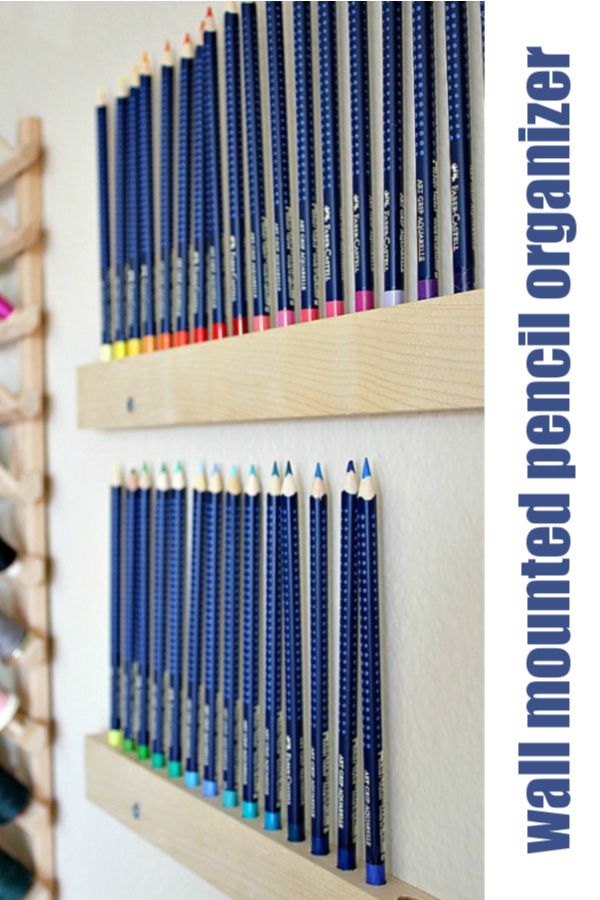 two wooden shelves filled with different colored pencils