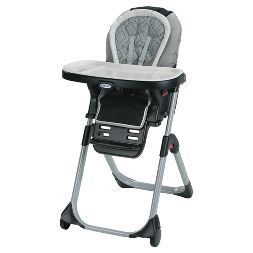 a baby high chair with wheels on the back and seat up against it's side