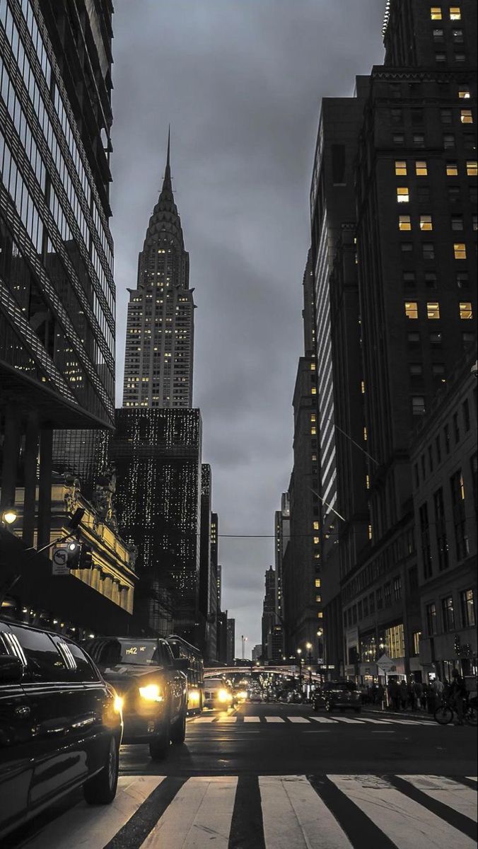 cars driving down the street in front of tall buildings with text that reads best accommodations in new york you can book